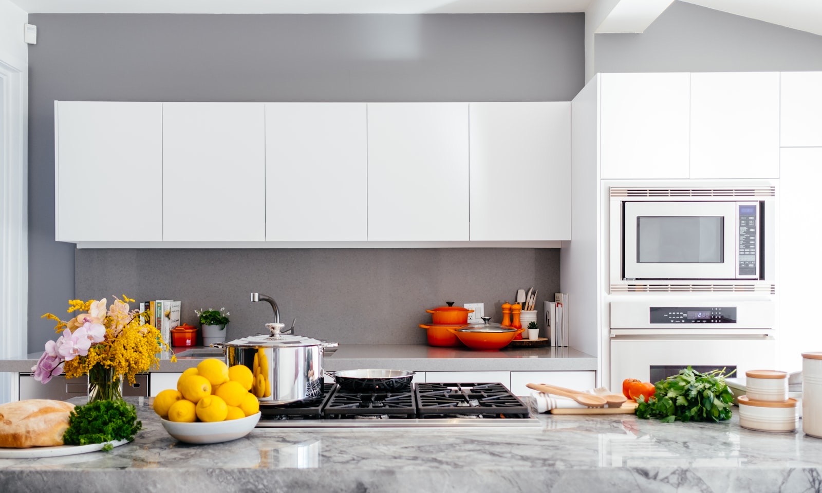 Bright kitchen counter with a pan on the hob and fresh food laid out