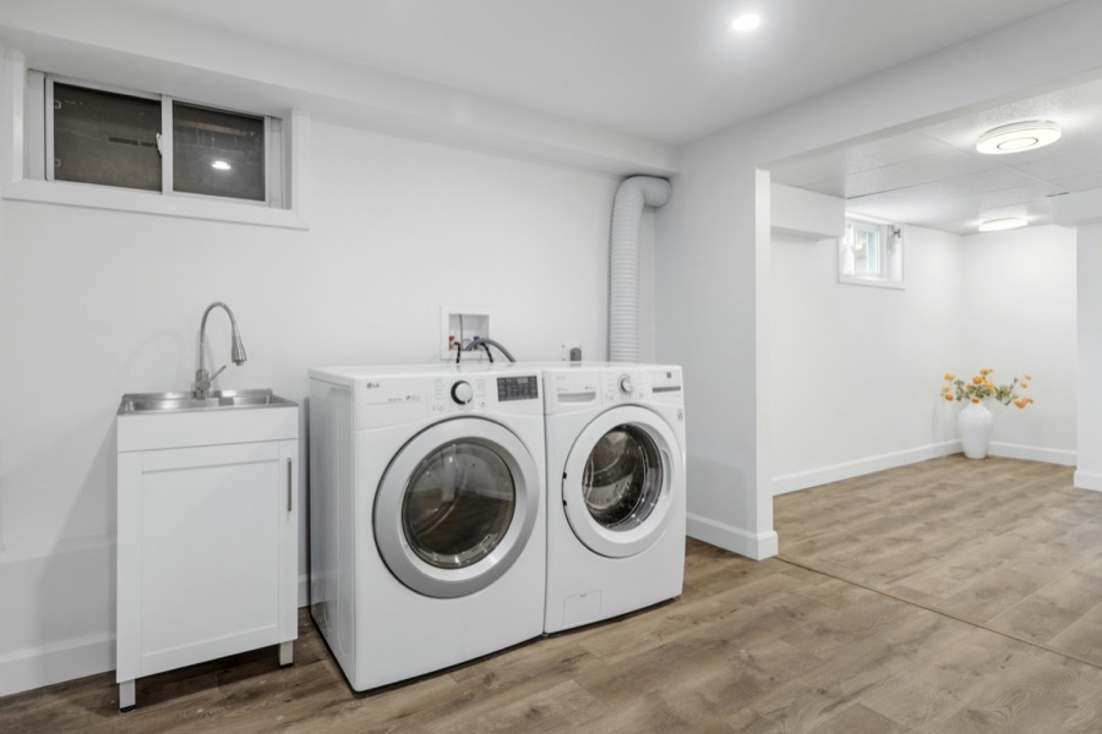 Clean laundry room with a washer, dryer and utility sink